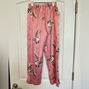 Pink satiny soft elastic waist lounging pants with side seam pockets.